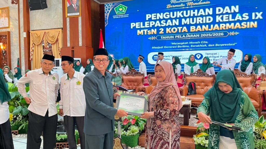 Kepala MTsN 2 Banjarmasin, Riduansyah, Serahkan Penghargaan kepada Guru Purna Tugas. Foto Dok Istimewa