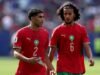 Manchester City Siapkan Ayyoub Bouaddi sebagai Suksesor Rodri, Transfer Bergantung pada Real Madrid Achraf Hakimi #2 dan Ayyoub Bouaddi #6 dari Timnas Maroko berjalan keluar lapangan saat jeda pertandingan perempat final Piala Dunia 2026 antara Prancis dan Maroko di Stadion Boston pada 10 Juli 2026 di Foxborough, Massachusetts. (Molly Darlington/Getty Images via AFP)